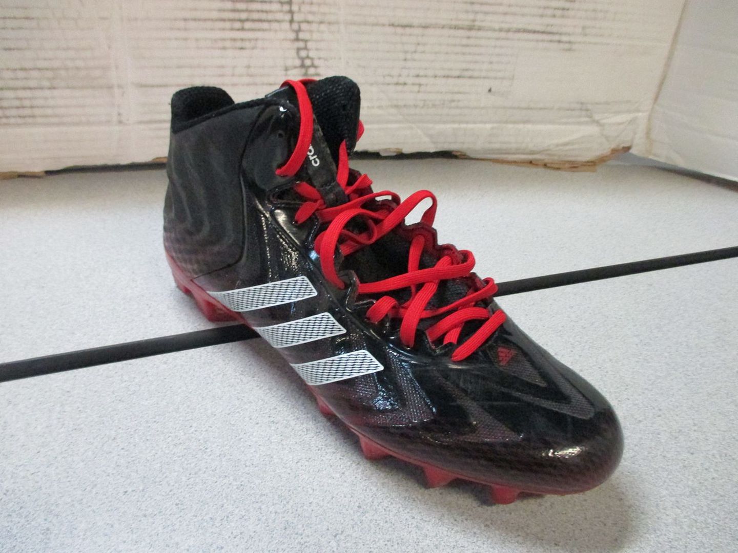 red and black football cleats mens